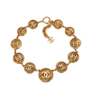CHANEL, a gold colored medallion CC necklace.