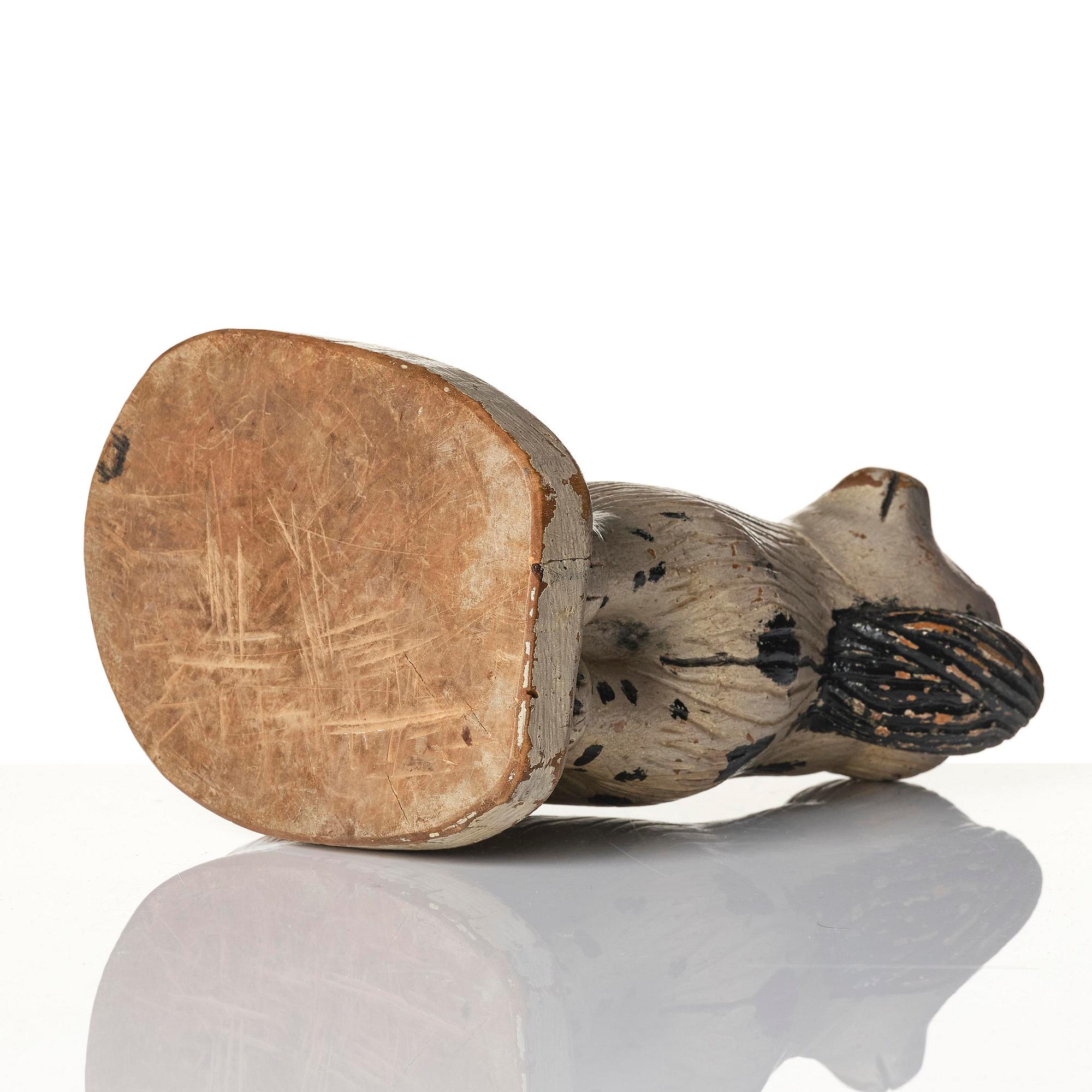 A Swedish wooden folk-art sculpture depicting a 'Staffordshire dog' ceramic figurine, 19th century.