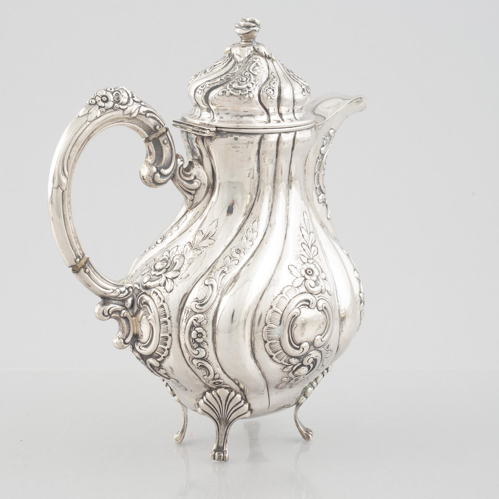 A Rococo-style silver coffee pot, creamer and sugar bowl, 20th Century.