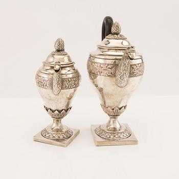 A three pcs Empire silver tea service unknown hallmarks, toal weight 1133 grams.