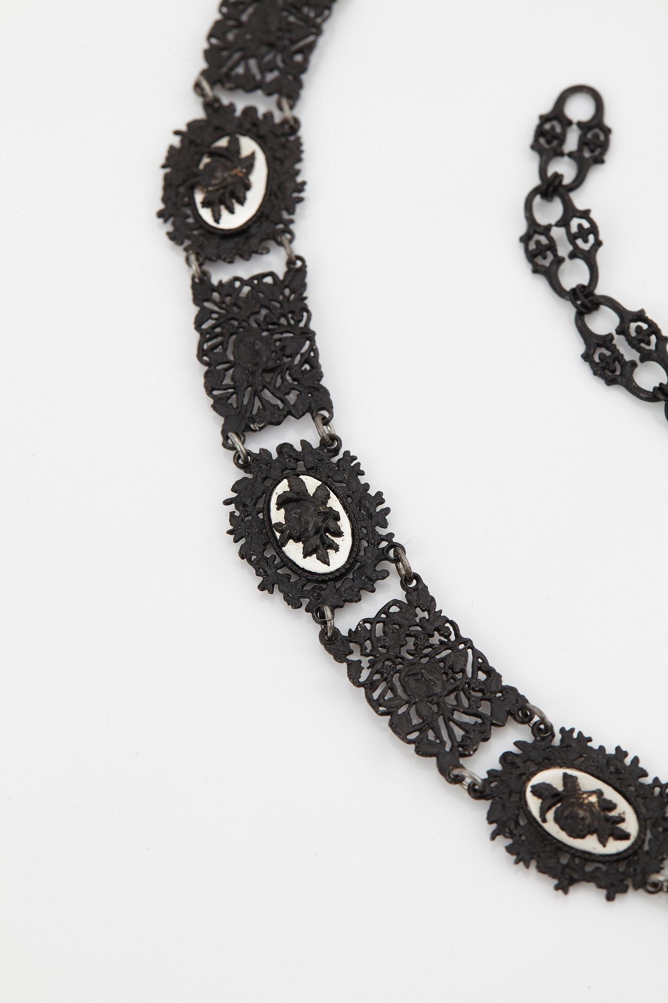 A Berlin steel and iron parure comprising a necklace, two bracelets and a brooch.