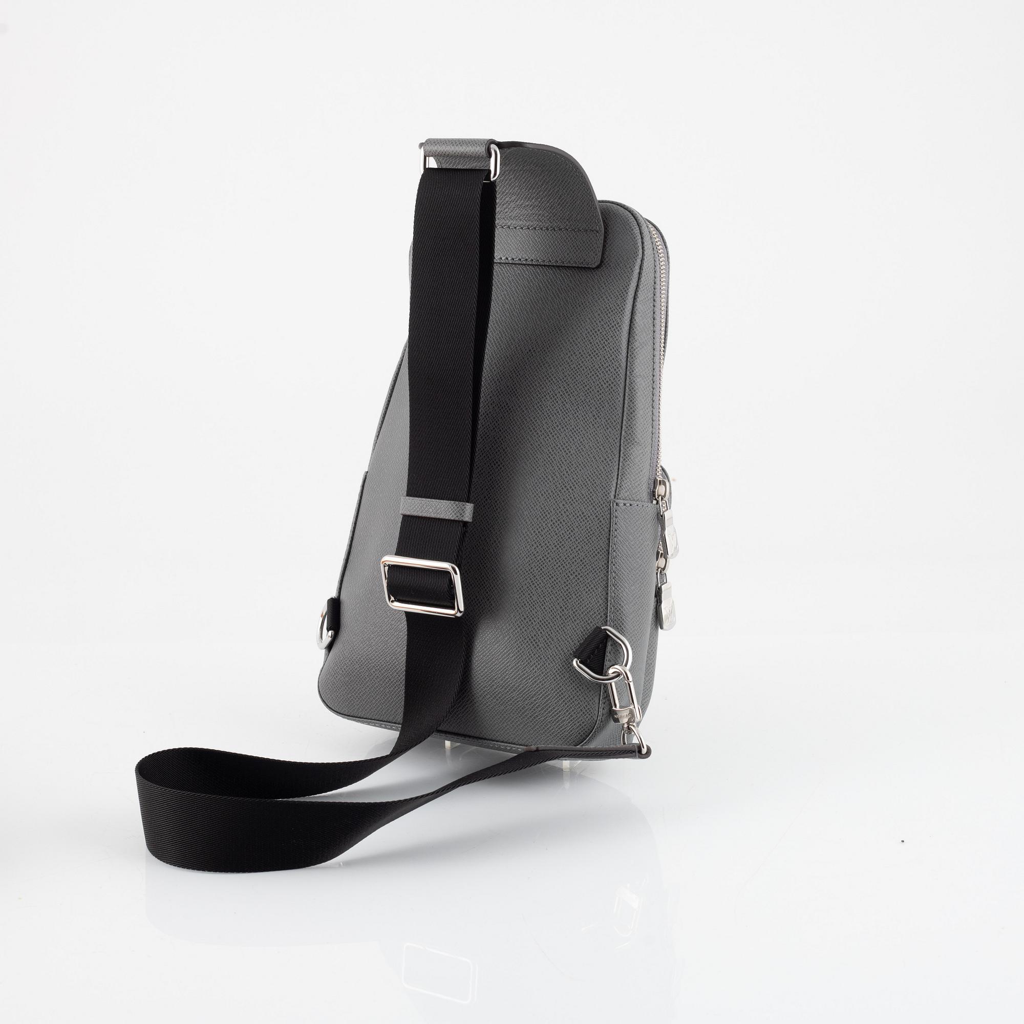 Louis Vuitton, a grey taiga 'Avenue' sling bag, 2022.
