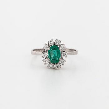 A emerald and brilliant cut diamond ring.