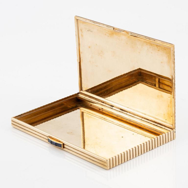 A Cartier 9 carat gold and calibré-cut sapphires cigarette case, London.