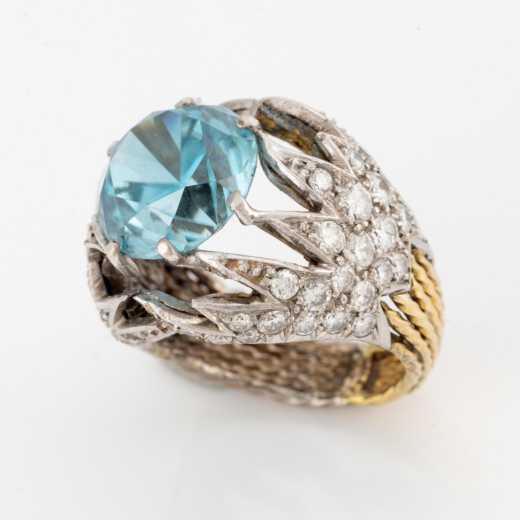 Sterlé ring 18K guld och platina med en blå fasettslipad zirkon och runda briljantslipade diamanter.