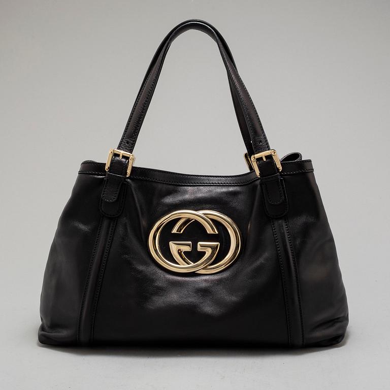 GUCCI, a leather hand bag.