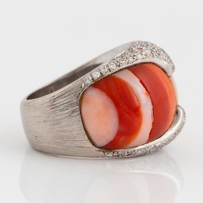 A Paul Binder ring in 18K white gold set with coral and round brillliant-cut diamonds.