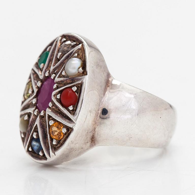 A sterling silver ring with multicoloured precious stones.