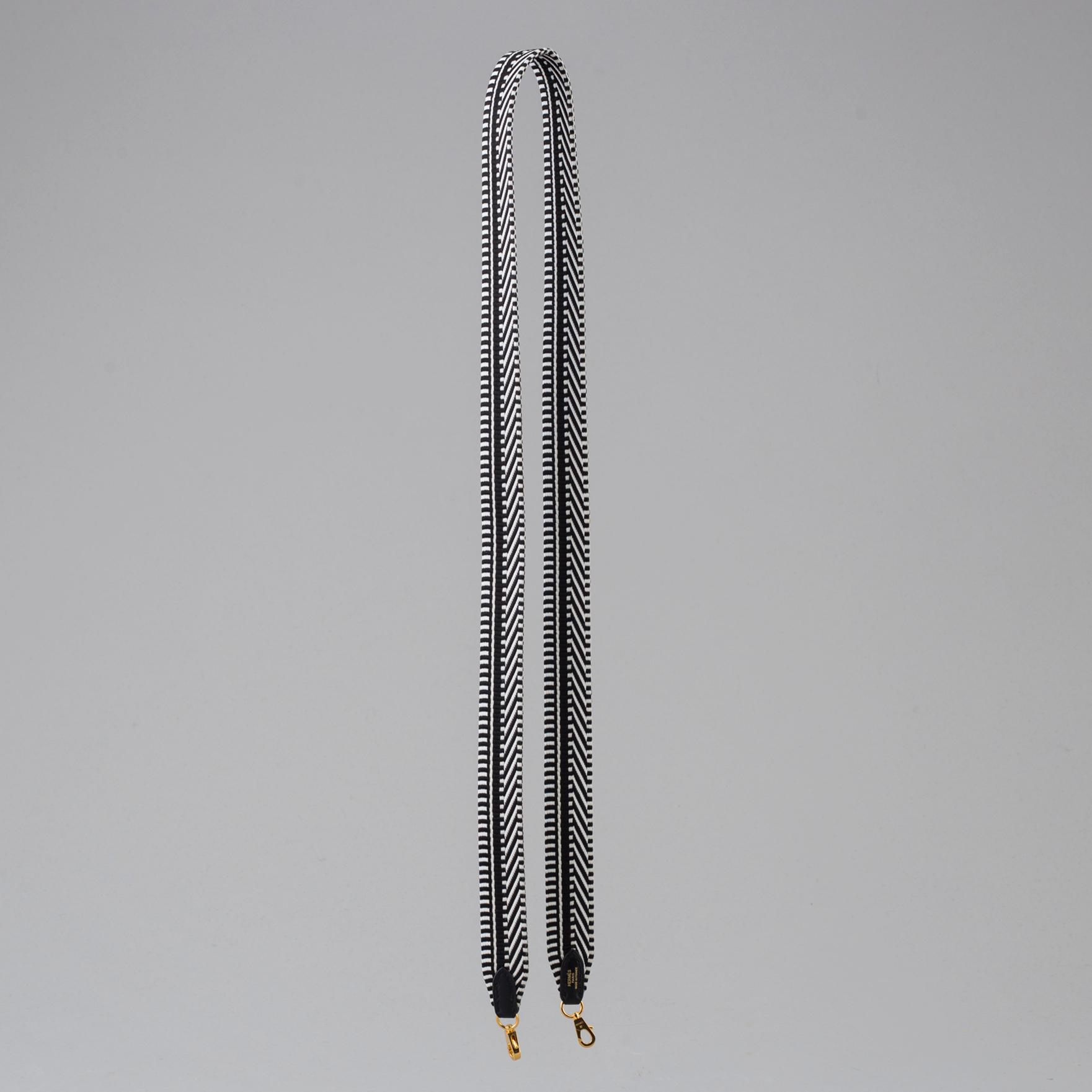 A bag strap by Hermès.