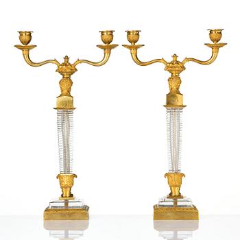 A pair of Empire ormolu and cut glass two-branch candelabra, Paris, early 19th century.