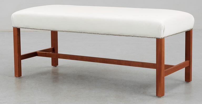 A Josef Frank cherry wood stool by Svenskt Tenn, model 2082.
