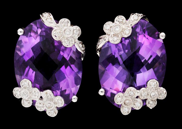 A pair of amethyst and diamond earclips.