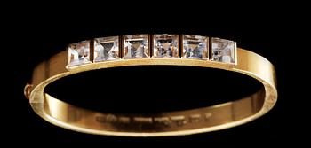 A Wiwen Nilsson 18k gold bangle with facet cut beryls.