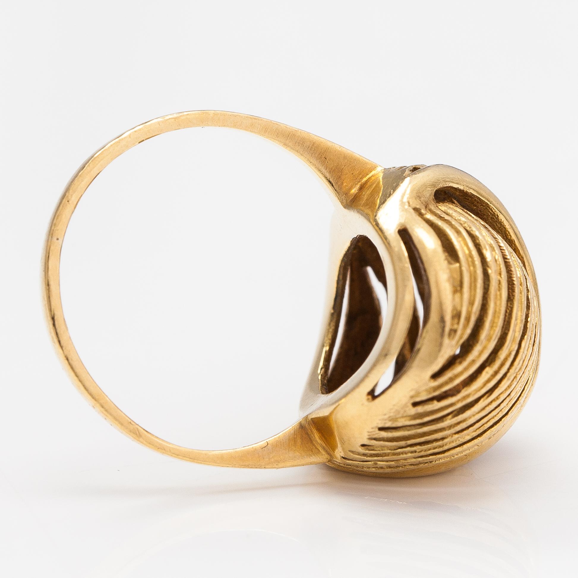A pair of earrings and a ring made of 14K gold.