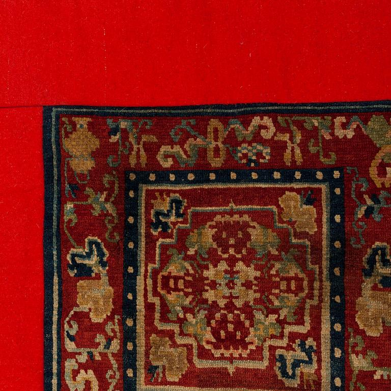 A MEDITATION RUG, one square, an antique Tibetan, ca 90,5 x 90,5 cm (including the fabric edgings).
