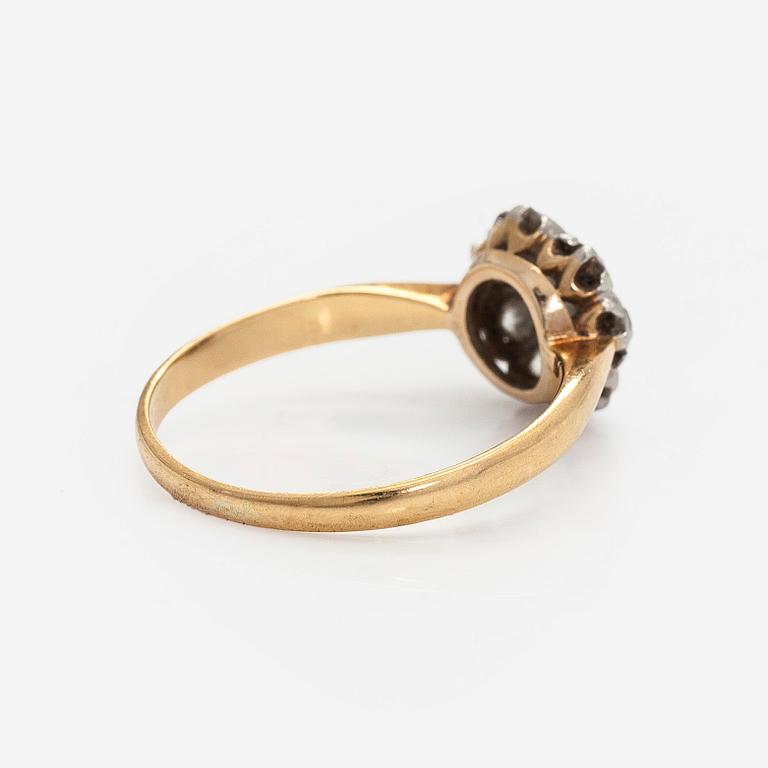 An 18K gold ring with old-cut diamonds.