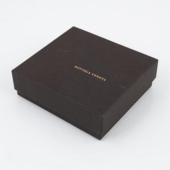Bottega Veneta, a wallet and bracelet.