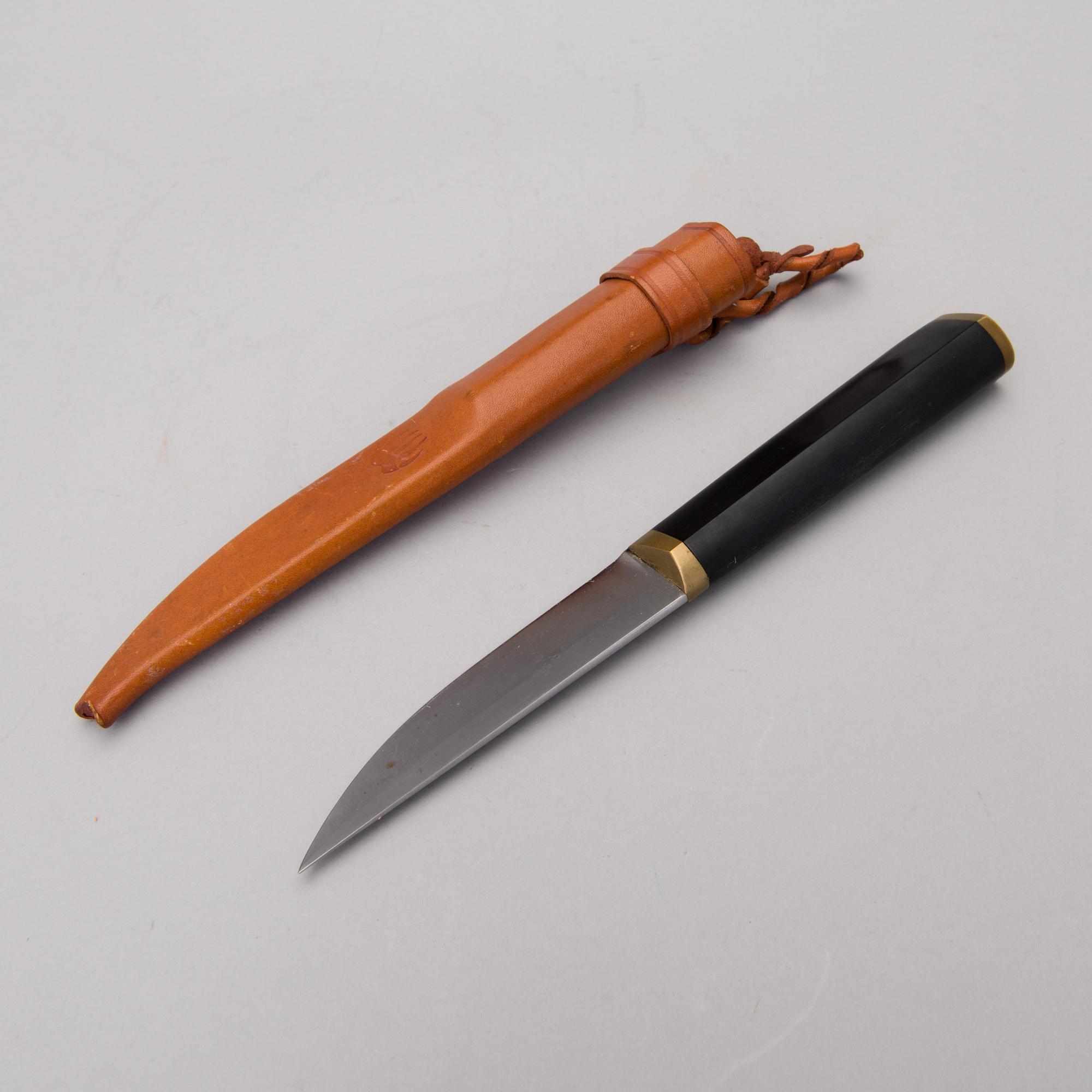 A Finnish puukko knife in stainless steel, nylon and brass