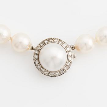 Necklace with cultured pearls, clasp in 18K gold with a half pearl and eight-cut diamonds.