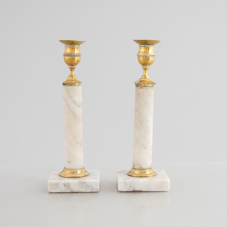 A pair of Gustavian gilt brass and marble candlesticks, late 18th century.