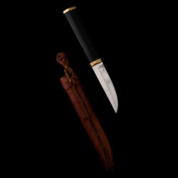 A Finnish puukko knife in stainless steel, nylon and brass designed by Tapio Wirkkala, Hackman Finland.