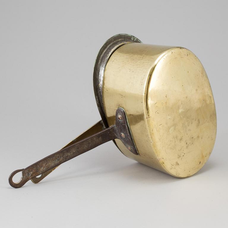 A BRASS AND CAST IRON SAUCEPAN AND COVER, 18th century.