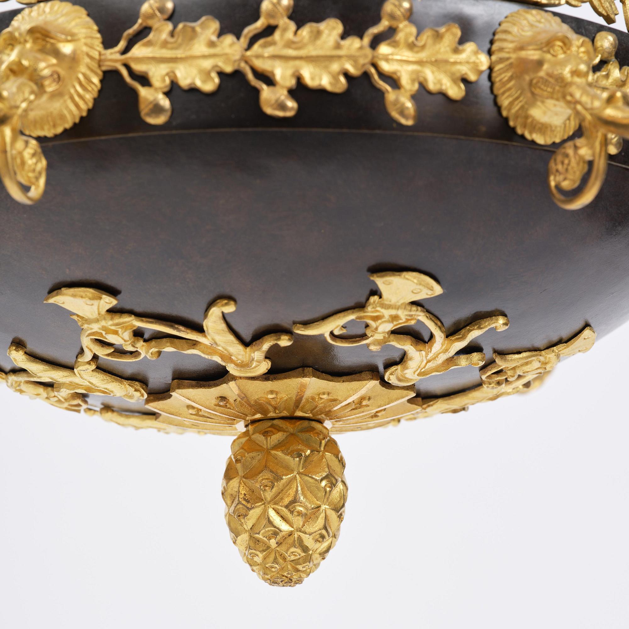 A patinated and ormolu six-light Empire chandelier, Stockholm, first part 19th century.