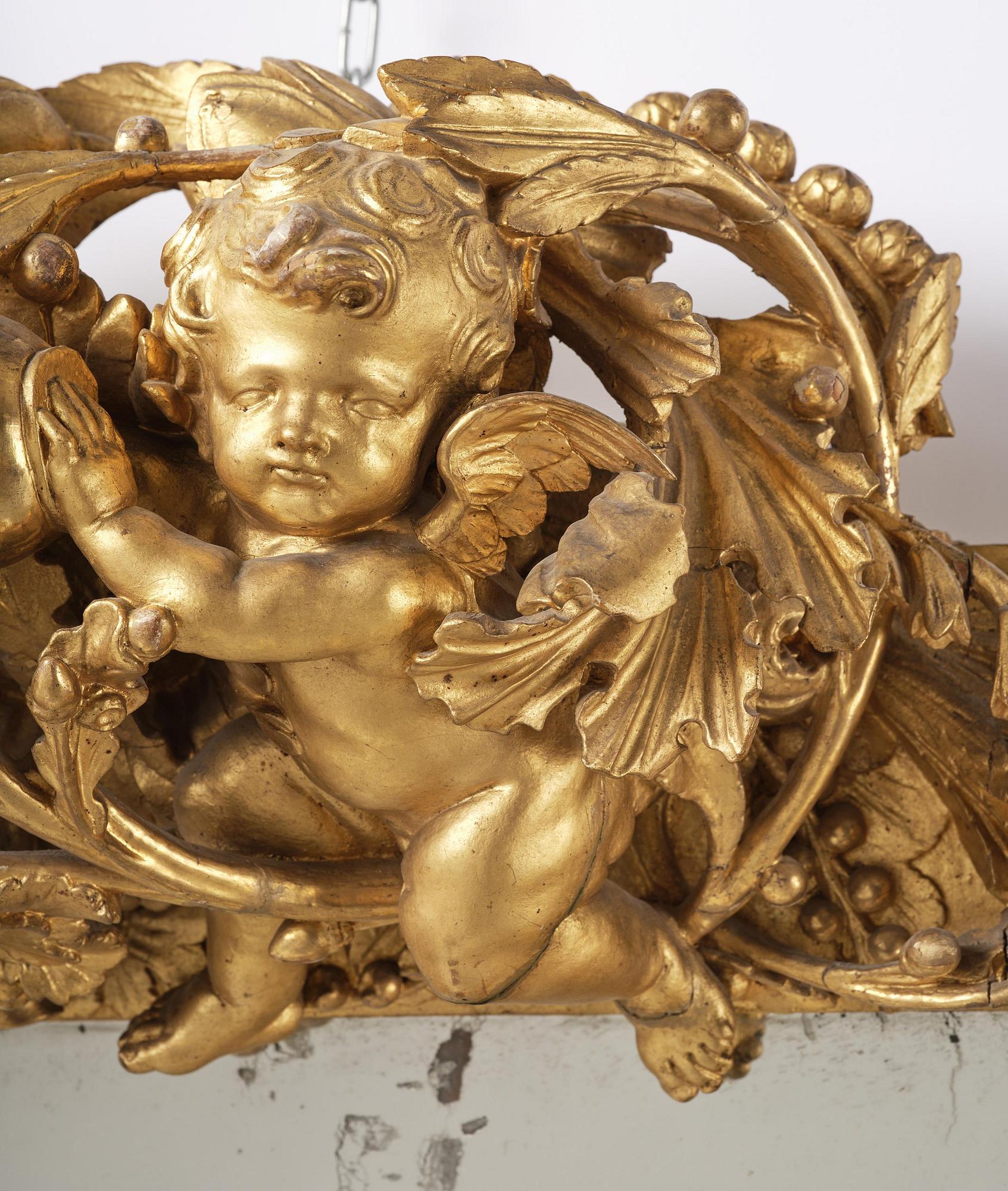 A presumably Dutch Louis XIV carved giltwood frame with mirror glass, in the style of Jean Le Pautre, late 17th century.