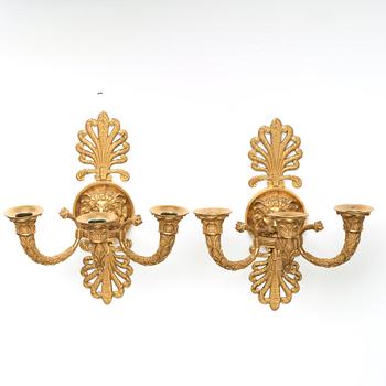 A pair of French Empire early 19th century three-light wall-lights.