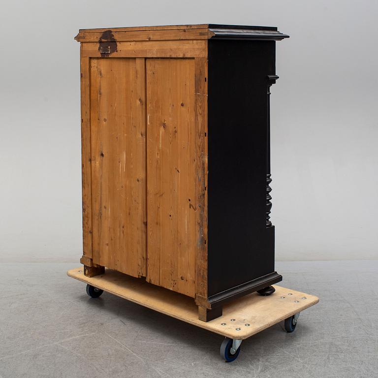 a painted chest of drawers from the late 19th century.