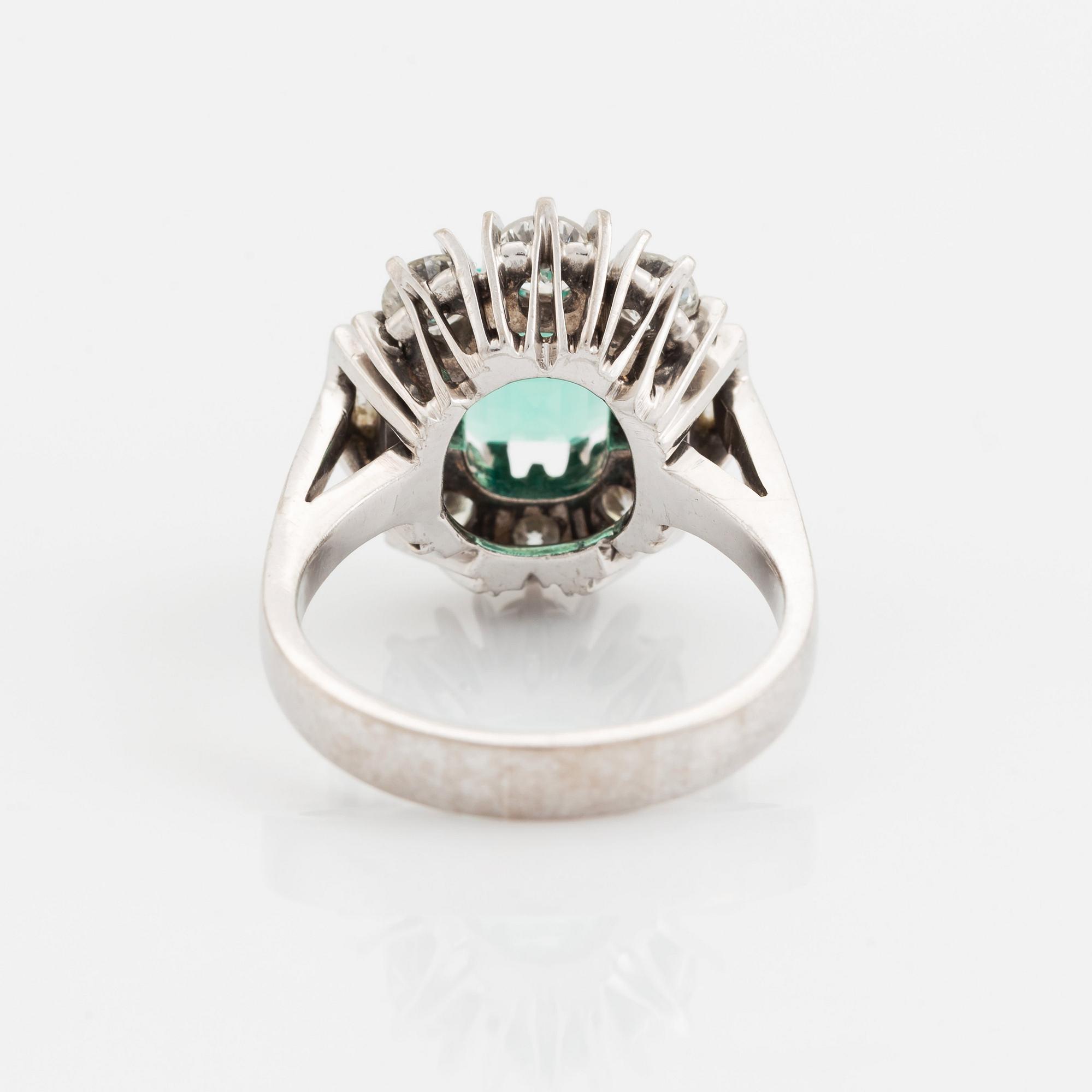 An 18K white gold ring set with a step-cut emerald.