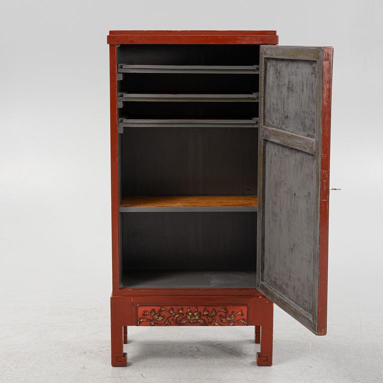 A Chinese cabinet, early 20th Century, with 19th Century carved panels.