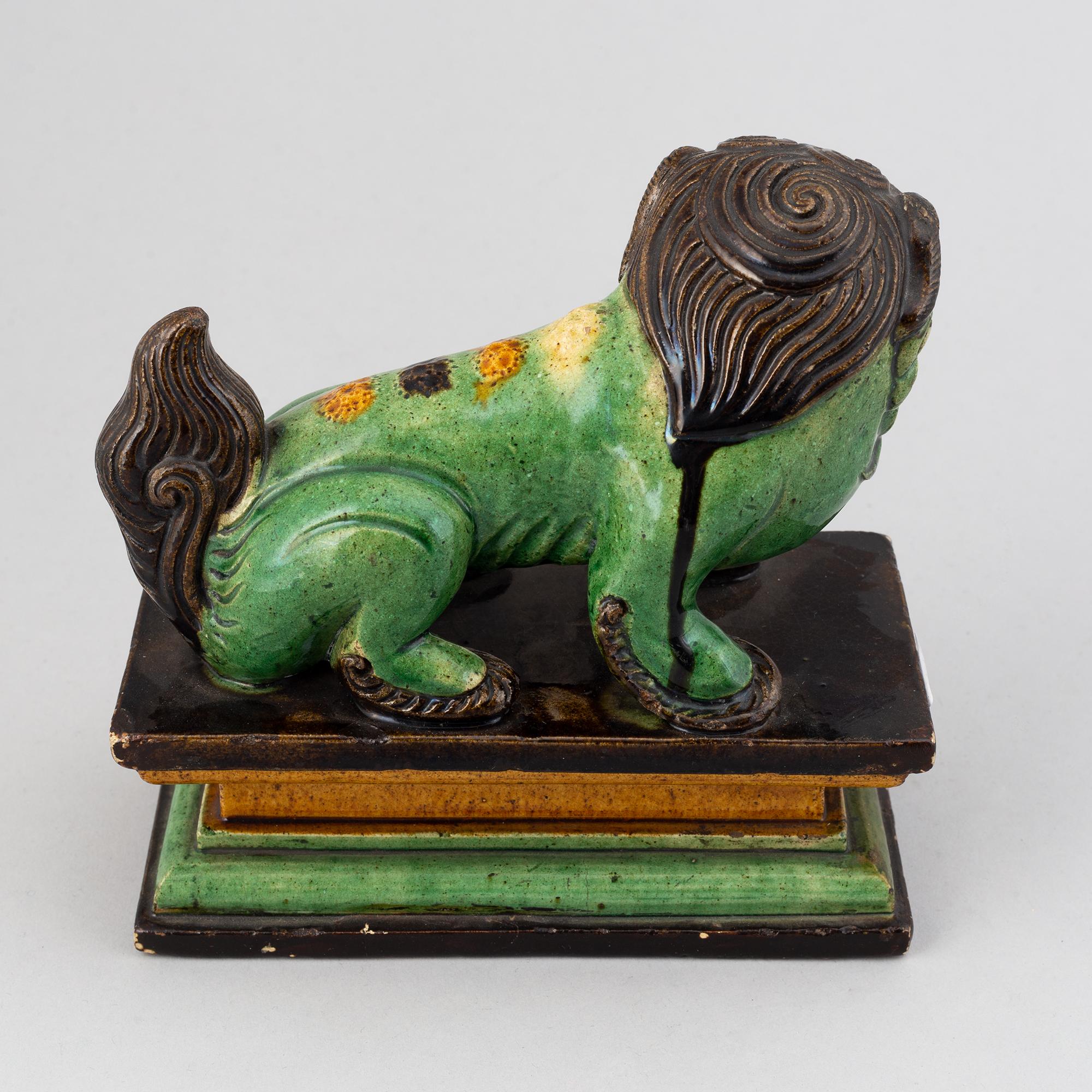 A green and yellow glazed buddhist lion, Qing dynasty, 19th Century.