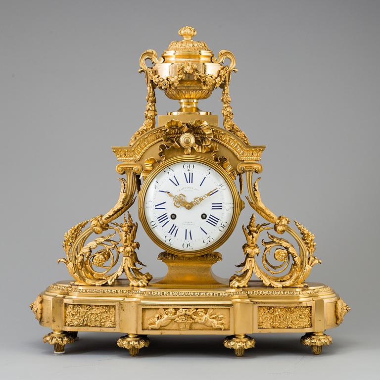 A Louis XVI-style late 19th century gilt bronze mantel clock.