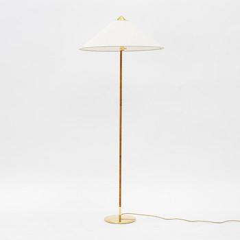 Paavo Tynell, A model 9602 brass and rattan floor lamp with canvas shade from Gubi,