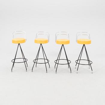 A 1970s bar and four stools.