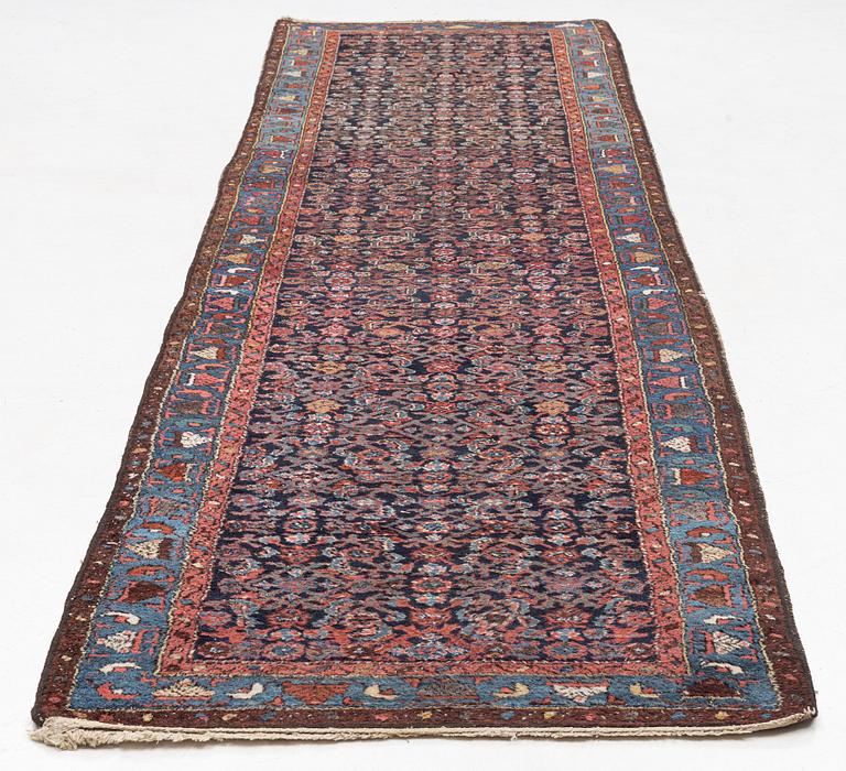 An Oriental runner carpet, circa 395 x 107 cm.