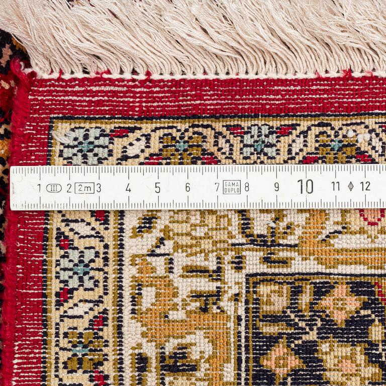 An oriental silk rug, approximately 258 x 178 cm.