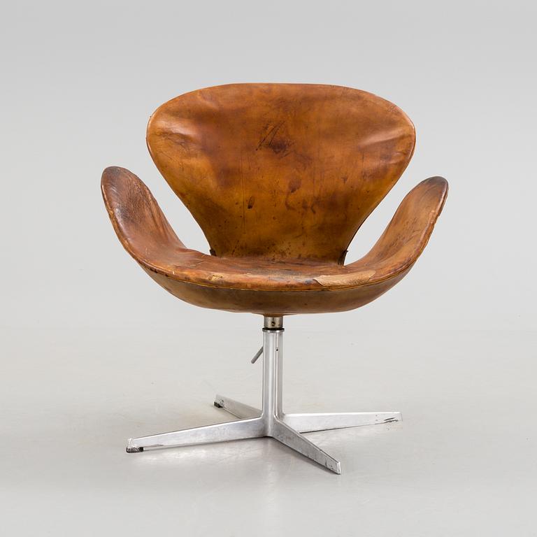 An Arne Jacobsen steel and brown leather 'Swan' chair, Fritz Hansen, Denmark 1960's.