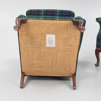 A pair of wingback armchairs and a footstool, England, second half of the 20th century.