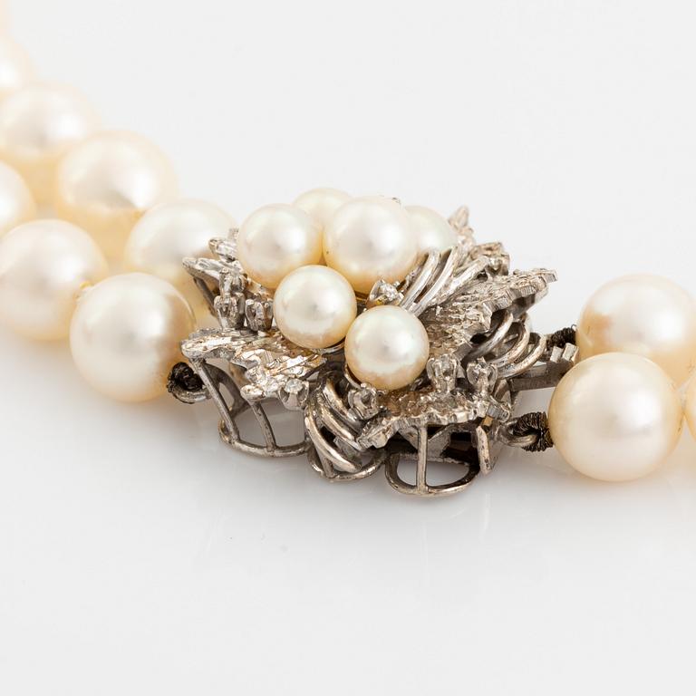 Cultured pearl necklace, clasp 14K white gold with pearl and eight cut diamonds.