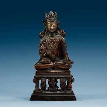 A western Tibetan/Kashmir bronze figure of Maitreya on a high throne, presumably 12th Century or older.