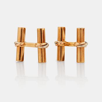 A pair of cufflinks signed Cartier with changeable  details in different gemstones.