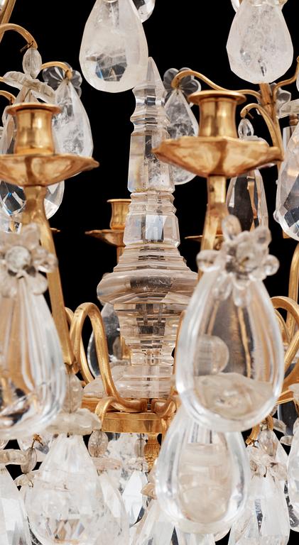 A late Baroque-style circa 1900 rock crystal twelve-light chandelier.