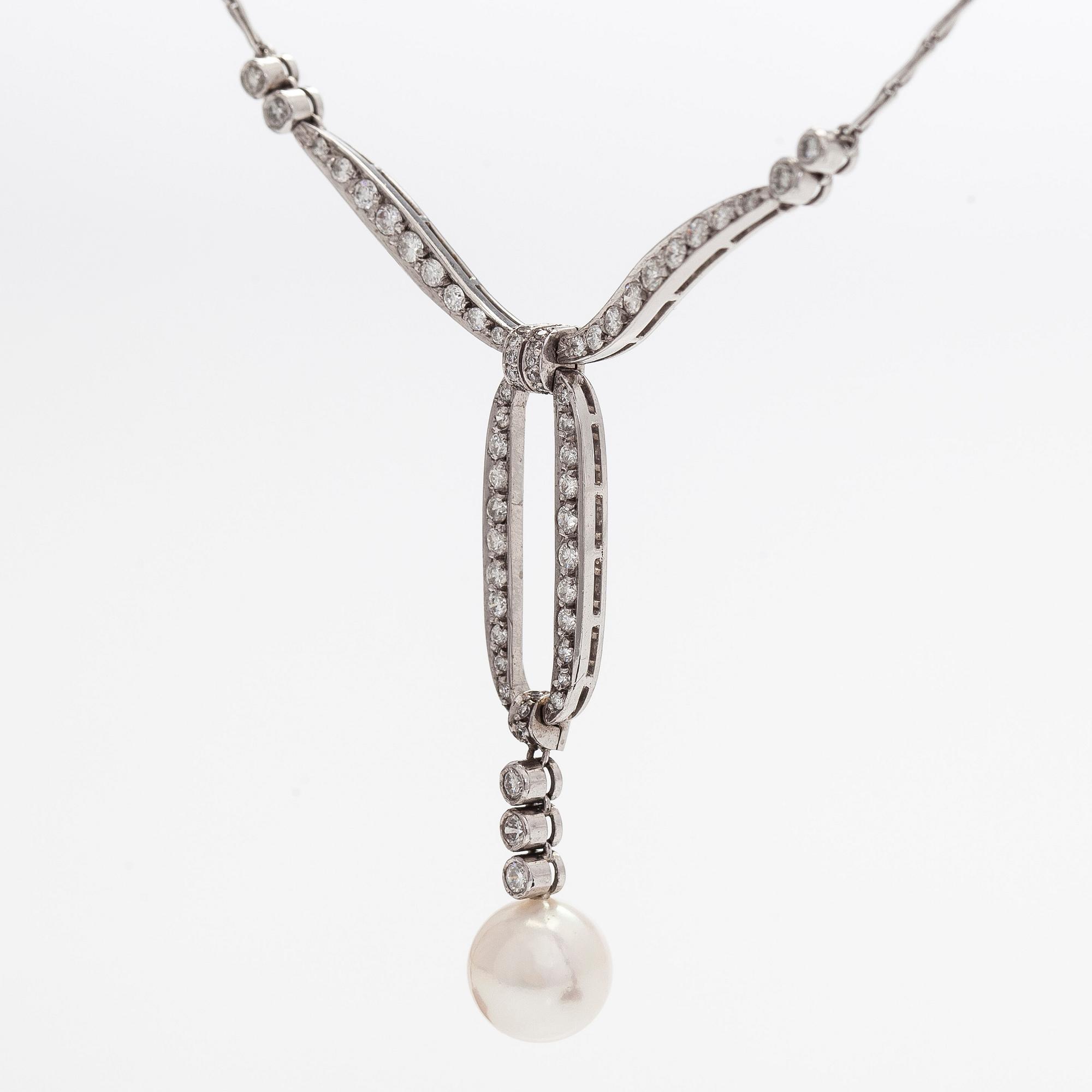 An 18K white gold necklace with brilliant-cut diamonds and a cultured pearl, England.