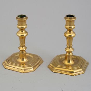 A pair of 18/19th century brass candlesticks.