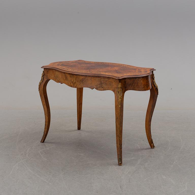 a rococo-style table/desk from England in the late 19th century.