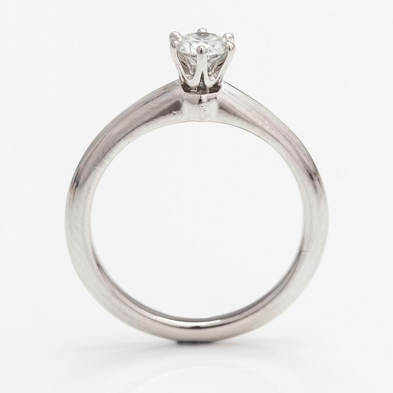Tiffany & Co, A platinum ring with a ca. 0.26 ct diamond.