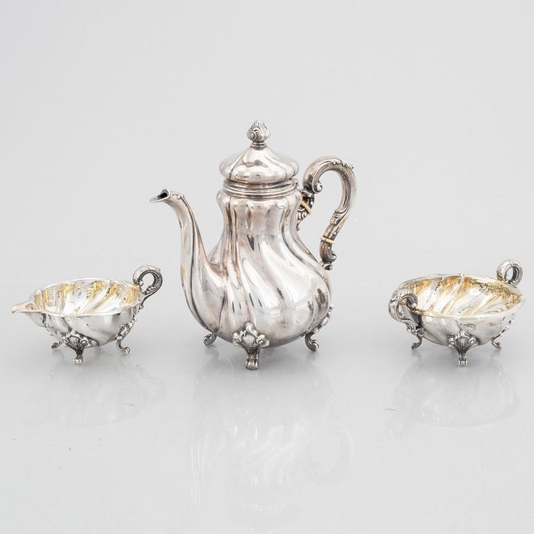 A Rococo Style Silver Coffee Pot, Creamer and Sugar Bowl, 20th Century, Swedish import mark.