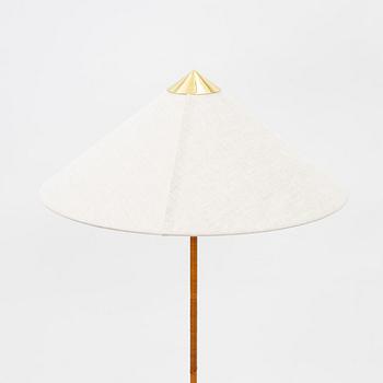 Paavo Tynell, A model 9602 brass and rattan floor lamp with canvas shade from Gubi,